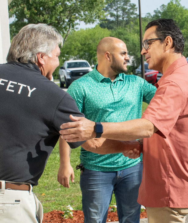 Men greeting each other outside the church