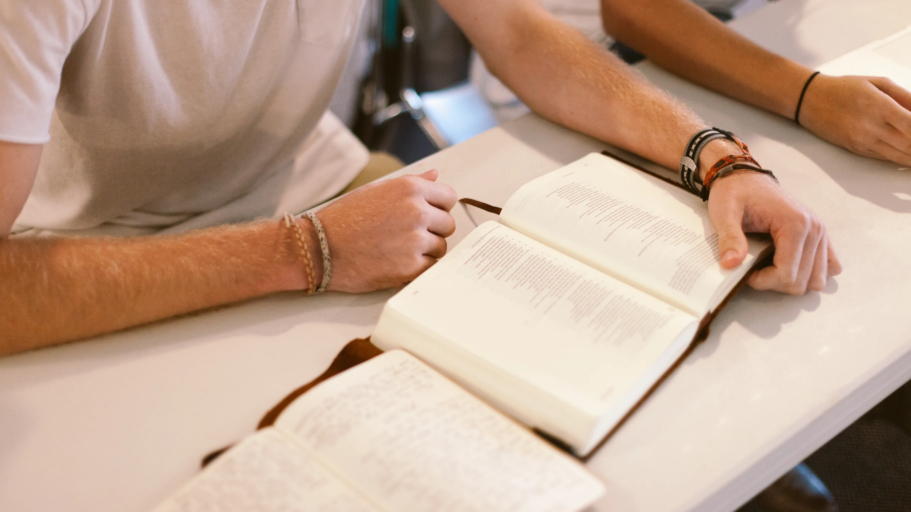 Open Bible and journal on a table during a group