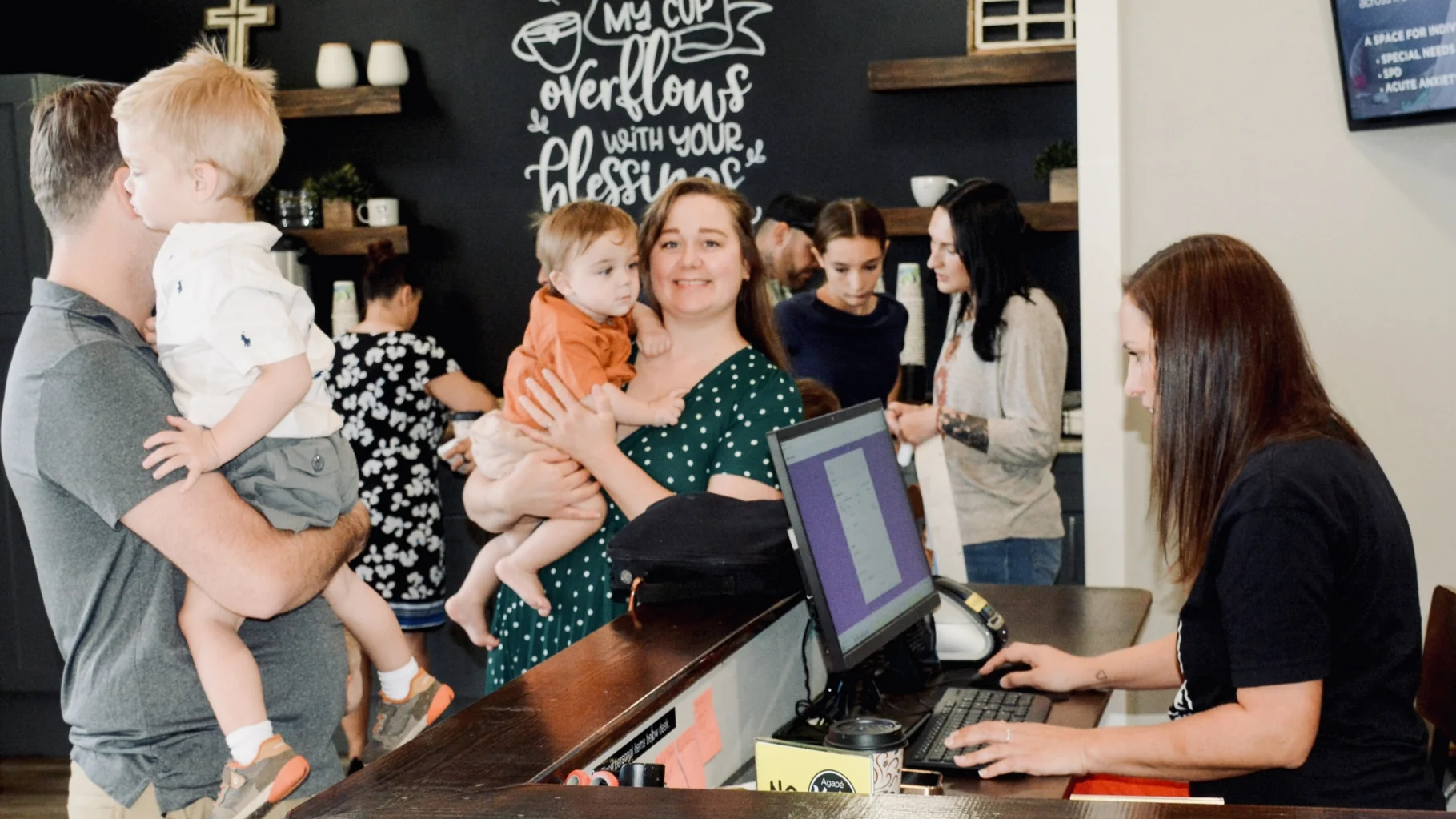 Parents checking in their kids at the welcome desk